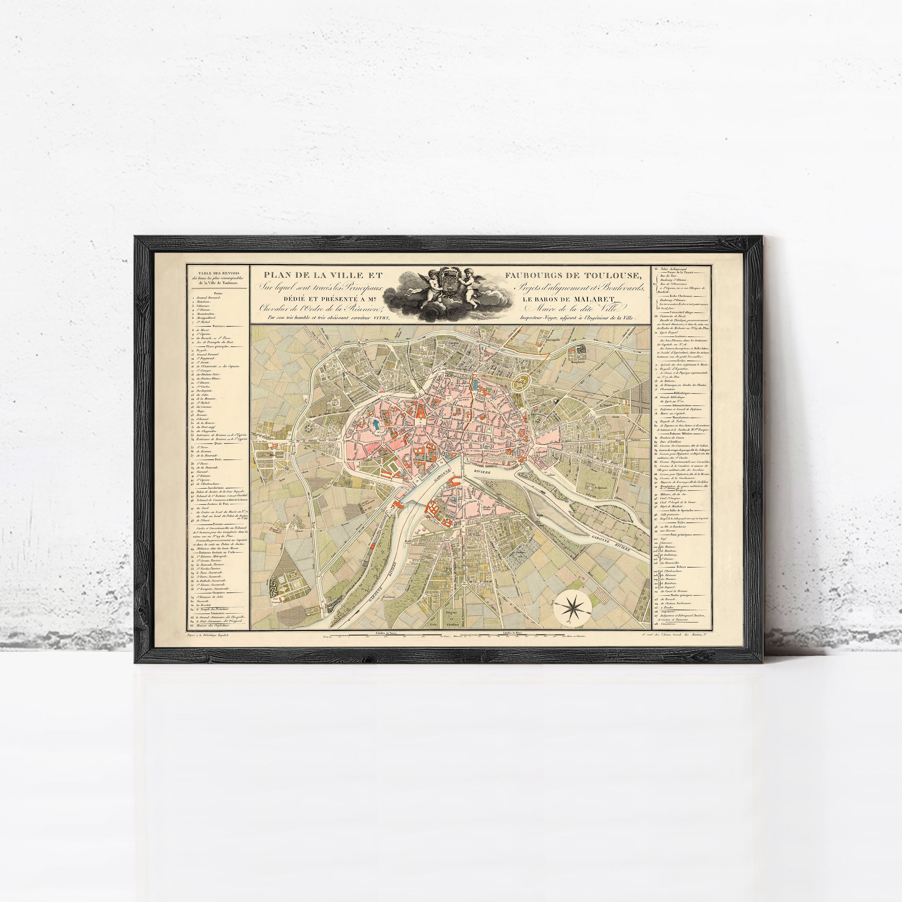 The image is a framed vintage map of a city, likely Paris, with detailed street names and landmarks.