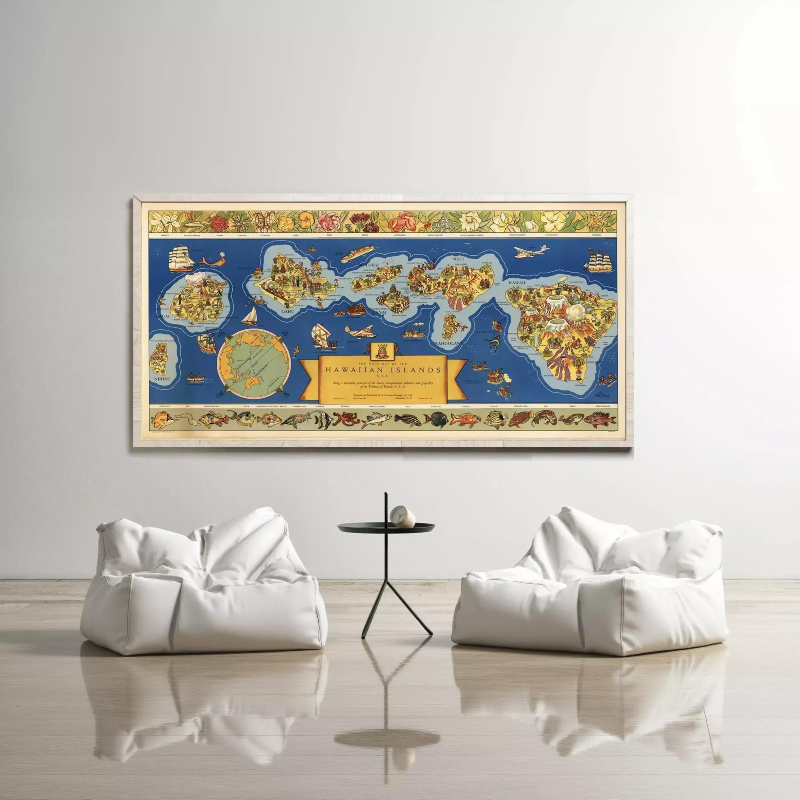 a large framed map of the Hawaiian Islands hanging on a wall, with two white bean bag chairs positioned in front of it.