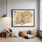 The image is a framed vintage map of Barcelona, Spain, depicting the city's streets, landmarks, and surrounding areas.
