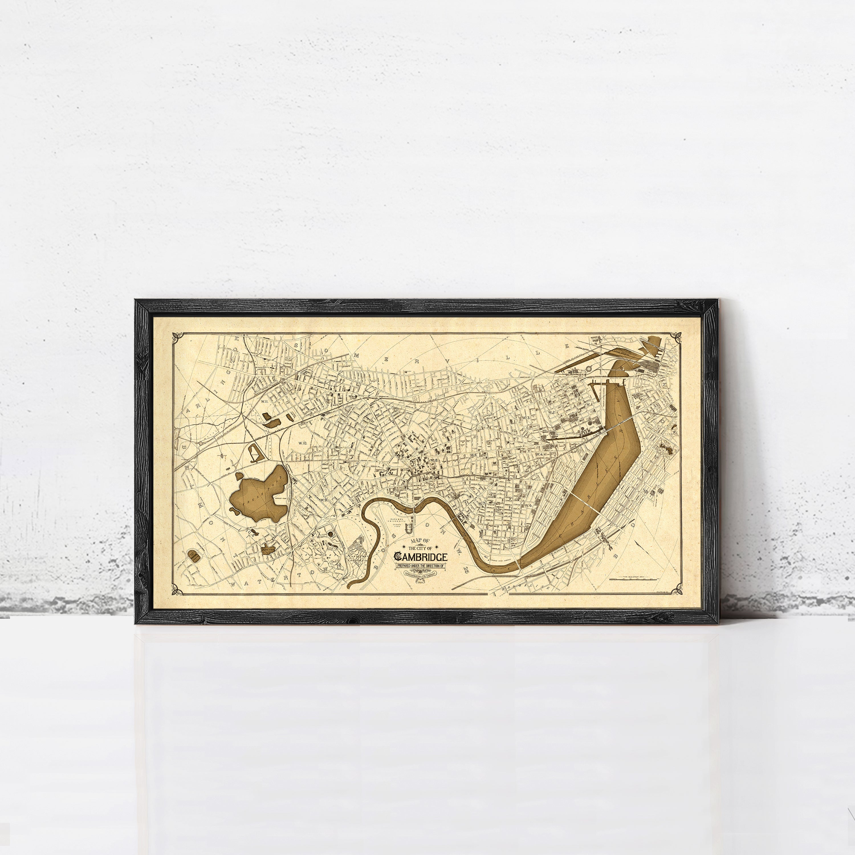 The image is a framed vintage map of Cambridge, Massachusetts, depicting a detailed layout of the city and surrounding areas.