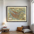 The image is a framed vintage map of a city, likely Paris, with detailed illustrations and labels.