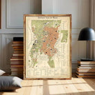 The image is a framed vintage map of a city, likely from the 19th century, with detailed geographical information and labels.