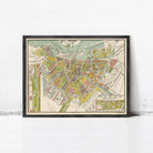 The image is a framed vintage map of Amsterdam, Netherlands, depicting the city's streets, canals, and surrounding areas.