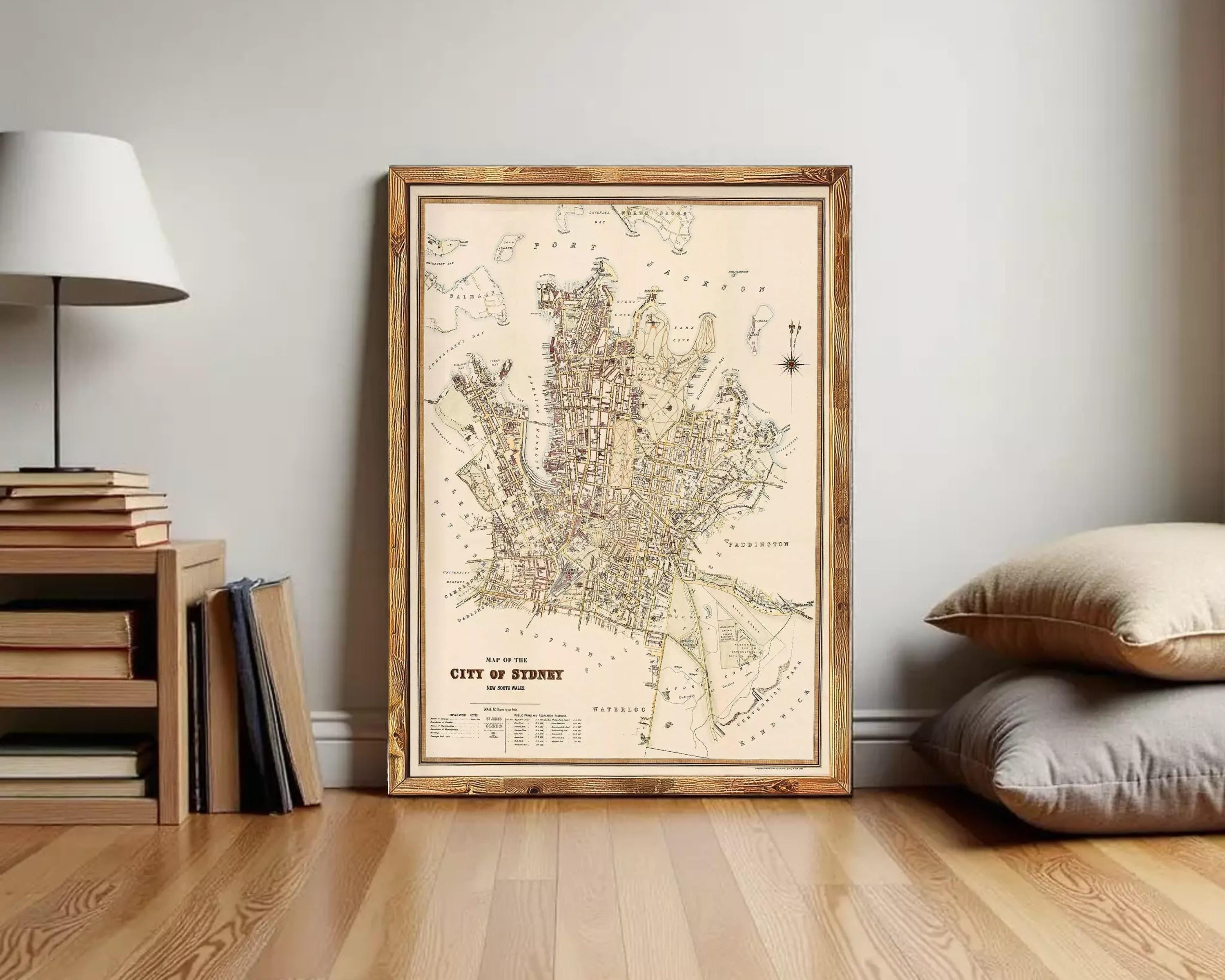 The image is a framed map of the city of Sydney, Australia, depicting the city's streets and surrounding areas.