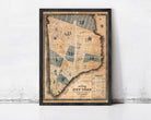 The image is a framed vintage map of New York City, depicting the city's streets and neighborhoods in a detailed and intricate manner.