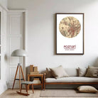a living room with a large circular map of Poznan hanging on the wall, a wooden side table with a lamp, a sofa with pillows, and a bookshelf filled with books.