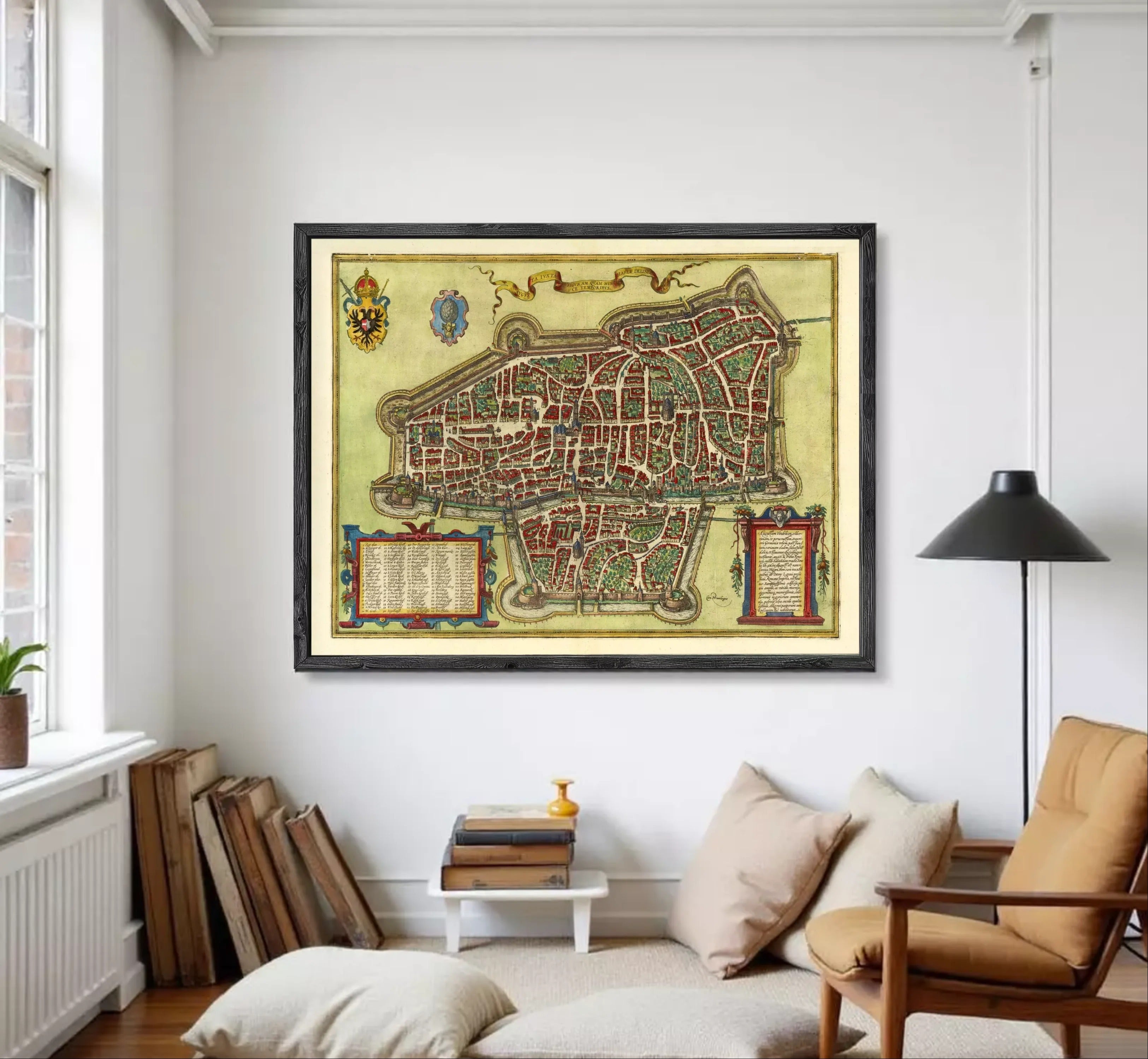 The image is a framed antique map of a city, likely from the Middle Ages, with intricate details and a decorative border.