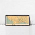 A framed map of Singapore is displayed against a white wall.