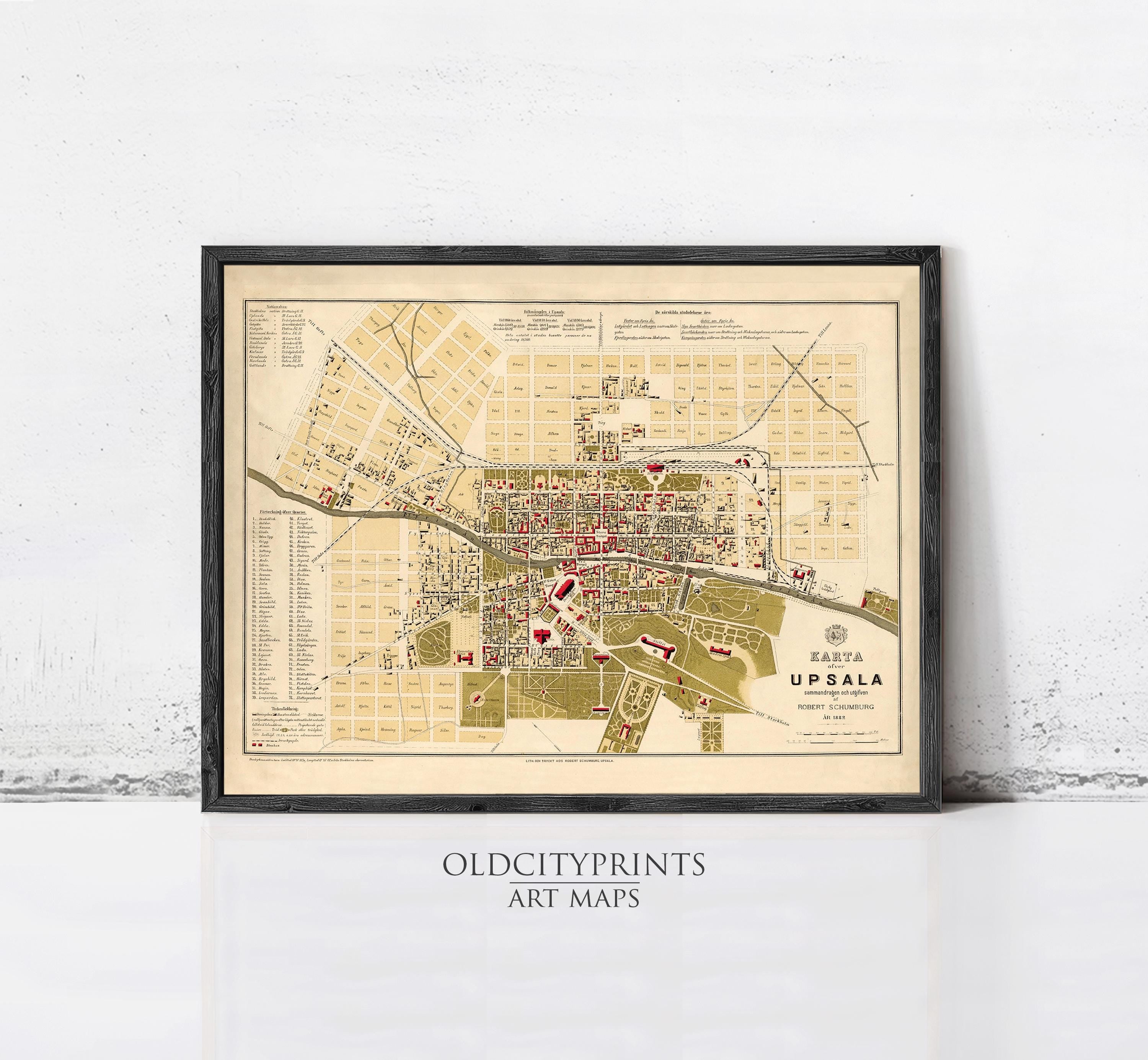 The image is a framed vintage map of a city, likely from the early 20th century, with various streets, buildings, and landmarks depicted.