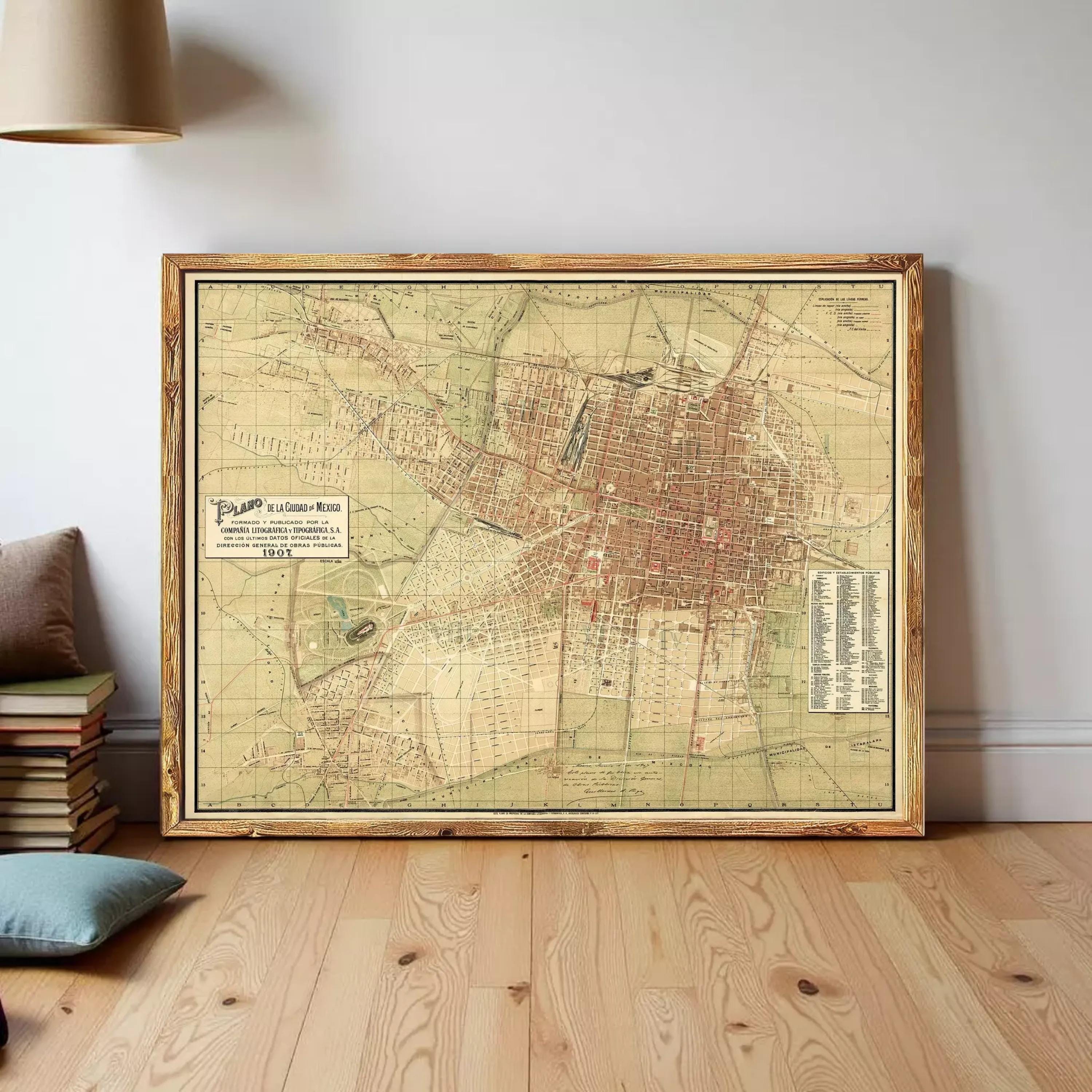The image is a framed vintage map of a city, likely from the 19th century, displayed on a white wall.