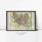 The image is a framed vintage map of a city, likely from the 16th century, with detailed labels and a color scheme of green, yellow, and red.