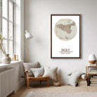 a cozy living room with a large framed map of Sicily hanging on the wall. The room has a comfortable seating area with a chair and a small table, as well as a bookshelf filled with books. The overall decor has a warm and inviting atmosphere.