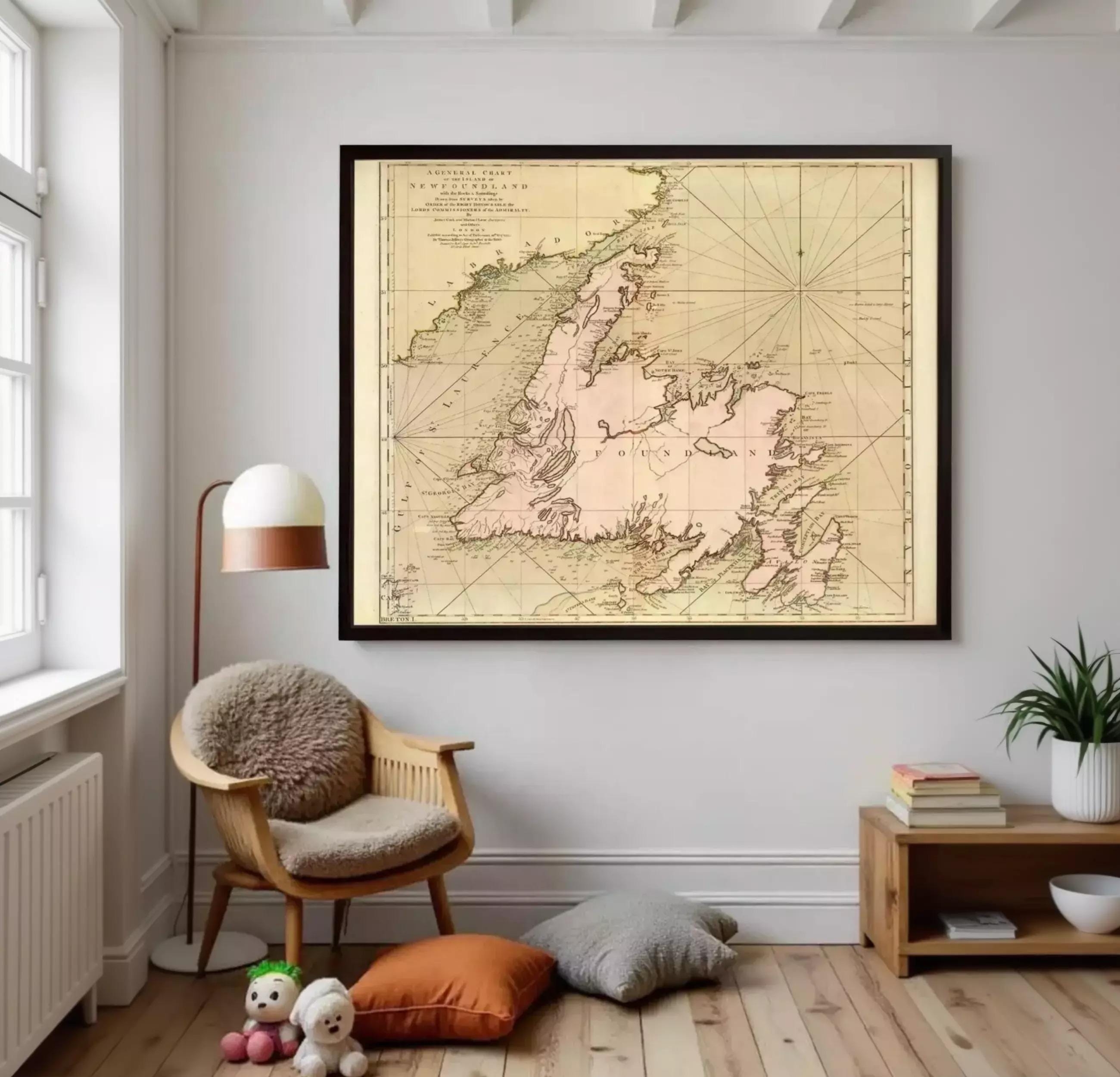 a large framed map of New England, a region in the United States, hanging on a wall in a room with a wooden floor.