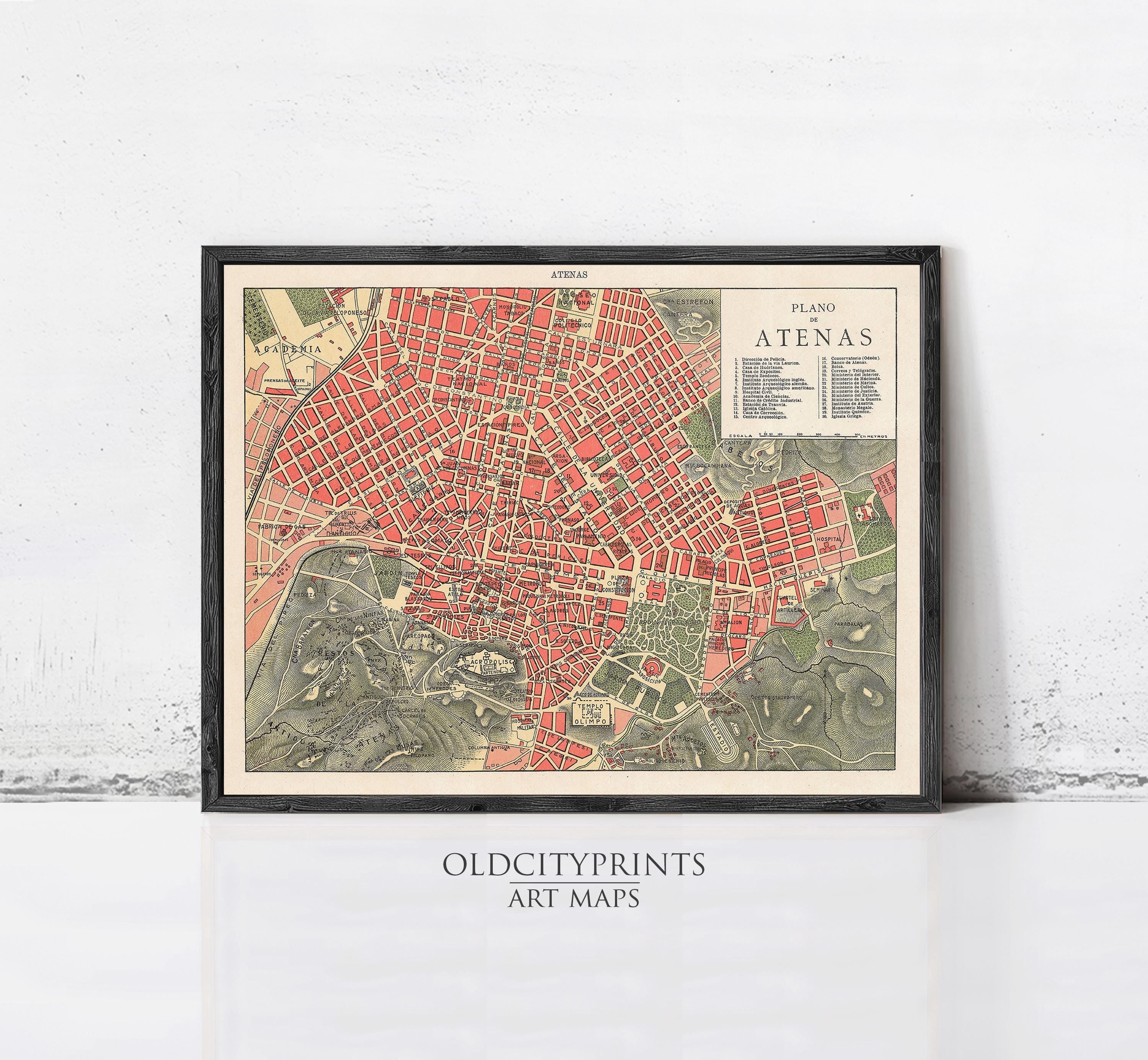 The image is a framed vintage map of the city of Atenas, depicting the streets, buildings, and other urban features in a detailed and colorful manner.