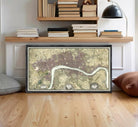 A framed map of London, England, with a river running through the city.