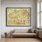 a large framed map hanging on a wall above a couch in a living room.