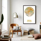 a living room with a wooden chair, a lamp, and a stack of books. A framed map of Seoul, South Korea, is hanging on the wall above the chair.