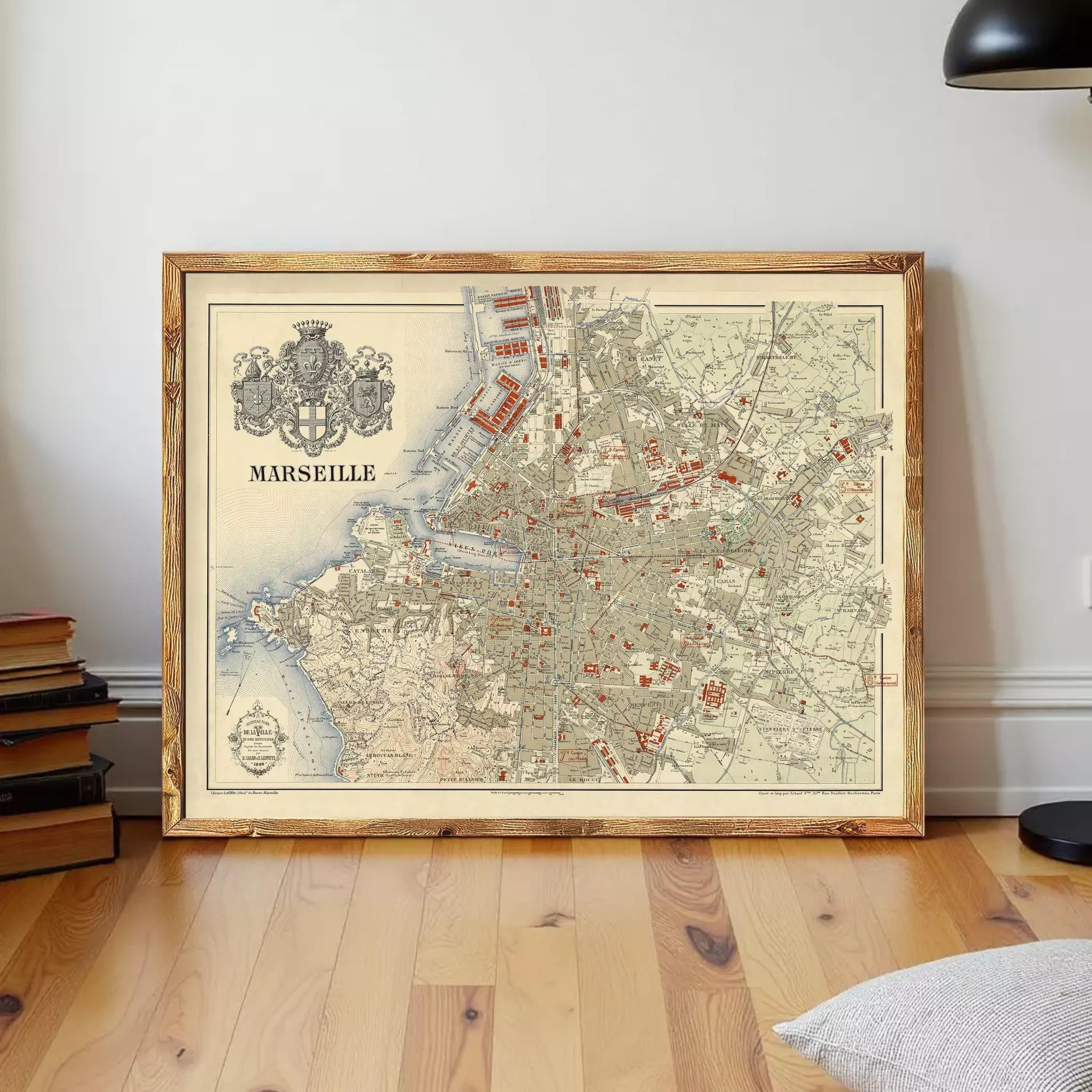a framed vintage map of the city of Marseille, France, with a wooden frame and a black and white color scheme.