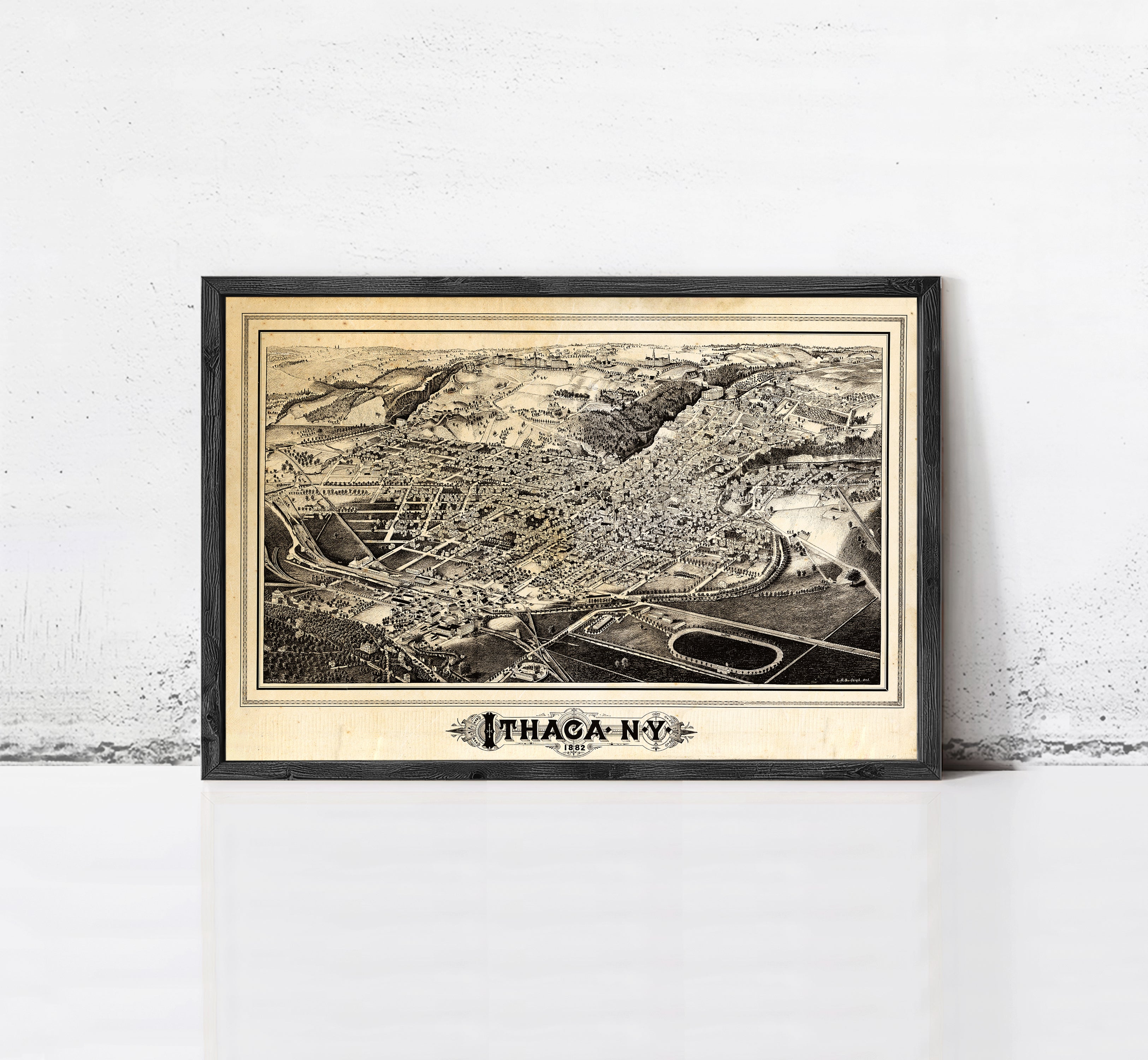 The image is a framed vintage map of Ithaca, New York, depicting the city's layout and surrounding areas.