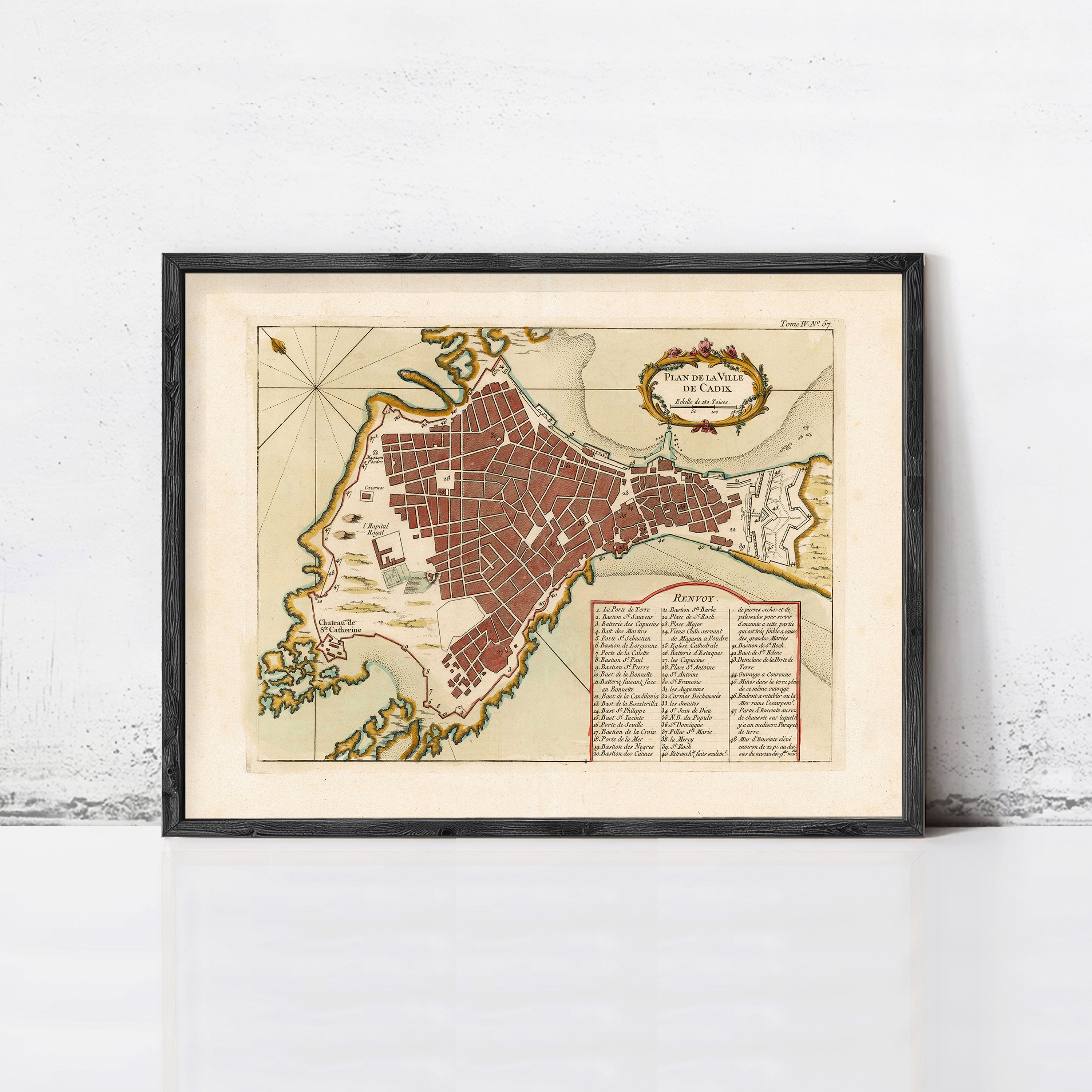 The image is a framed vintage map of a city, likely from the 16th century, depicting a detailed layout of the city's streets and surrounding areas.