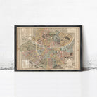 The image is a framed vintage map of a city, likely from the 19th century, displayed on a white wall.
