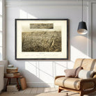 The image is a framed print of a large aerial view of a city, depicting a densely populated urban landscape with numerous buildings and streets.
