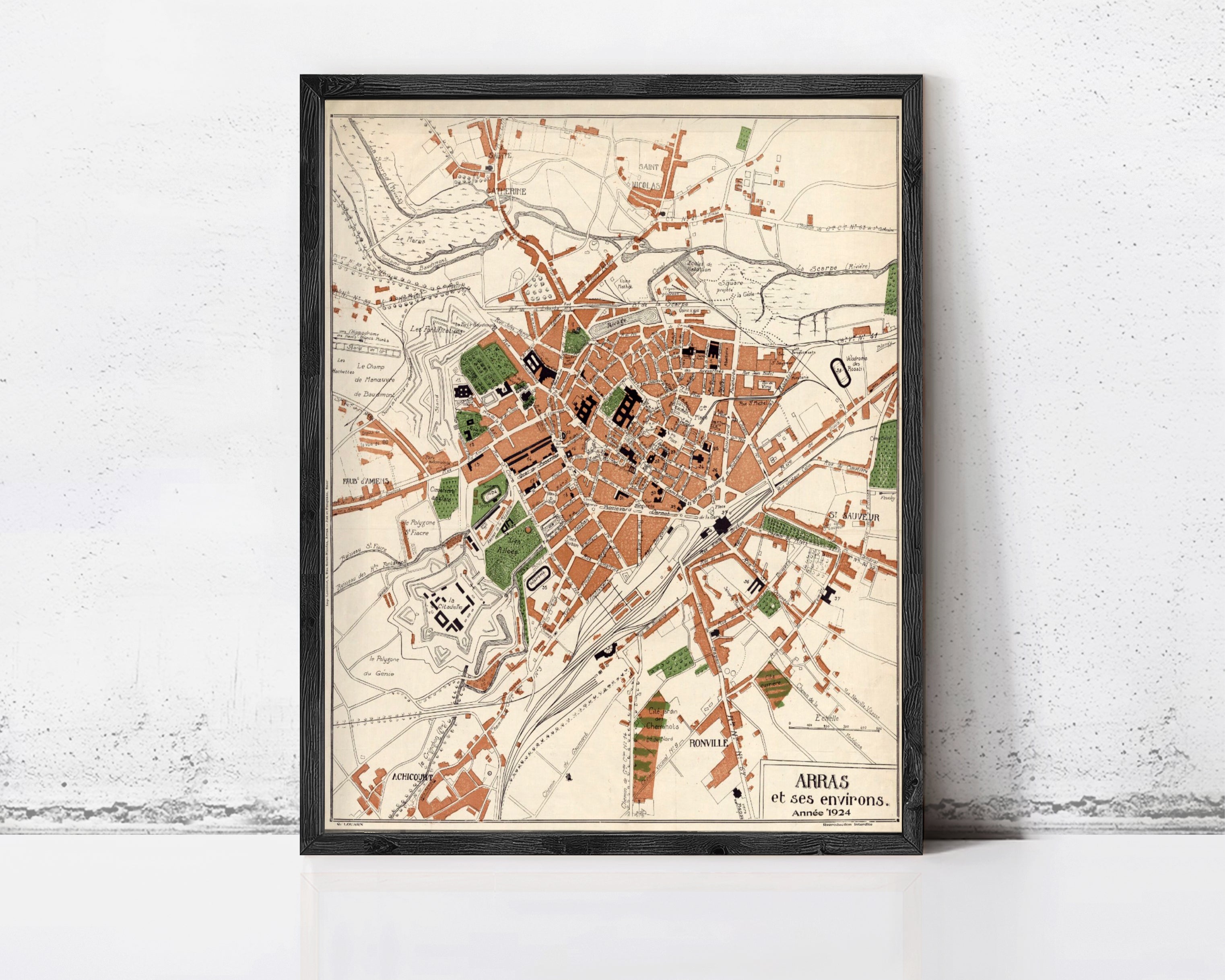 The image is a framed map of a city, depicting various landmarks and streets.