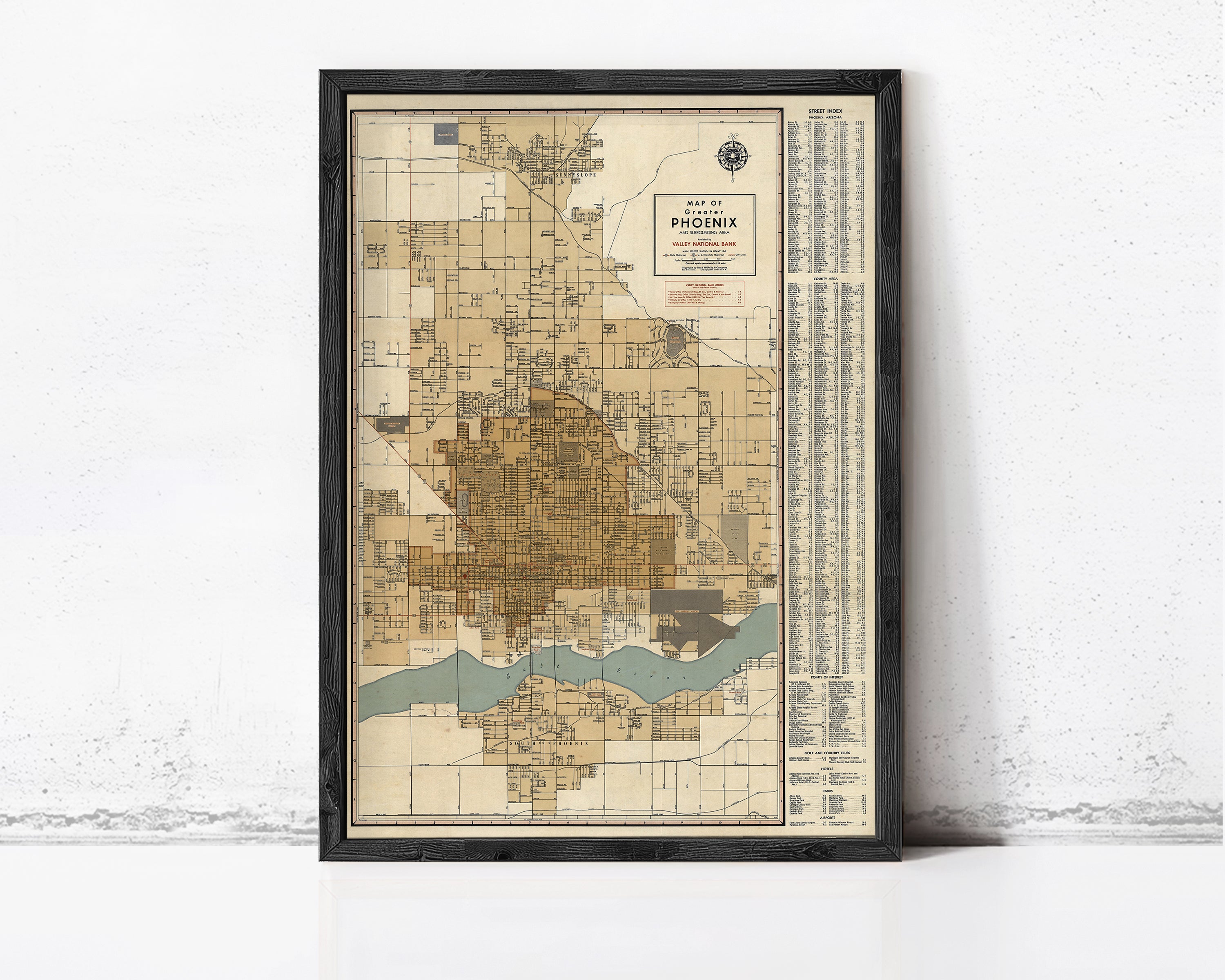 The image is a framed vintage map of Phoenix, Arizona, showing the city's layout and surrounding areas.