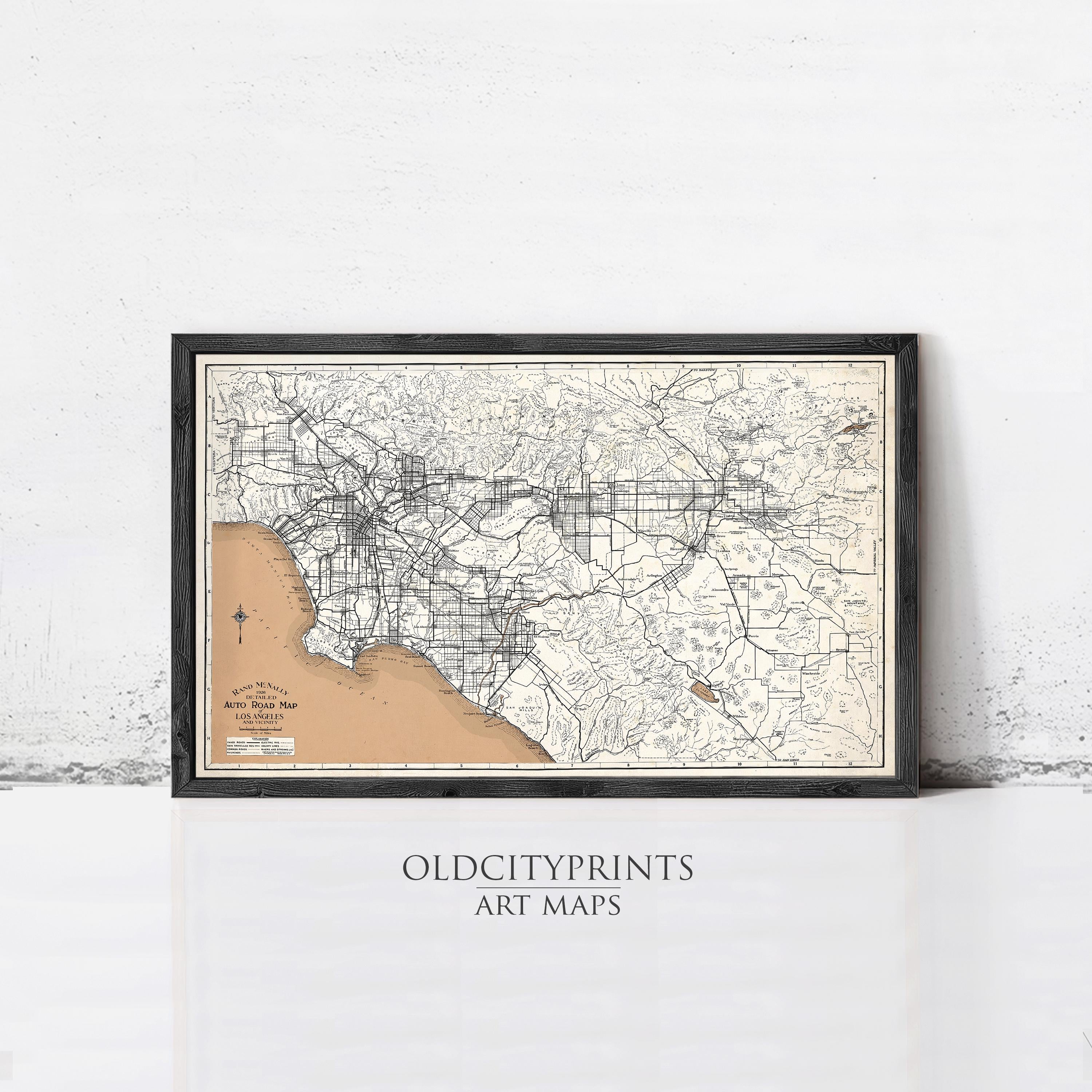 The image is a framed vintage map of Los Angeles, California, with a black border and a beige background.