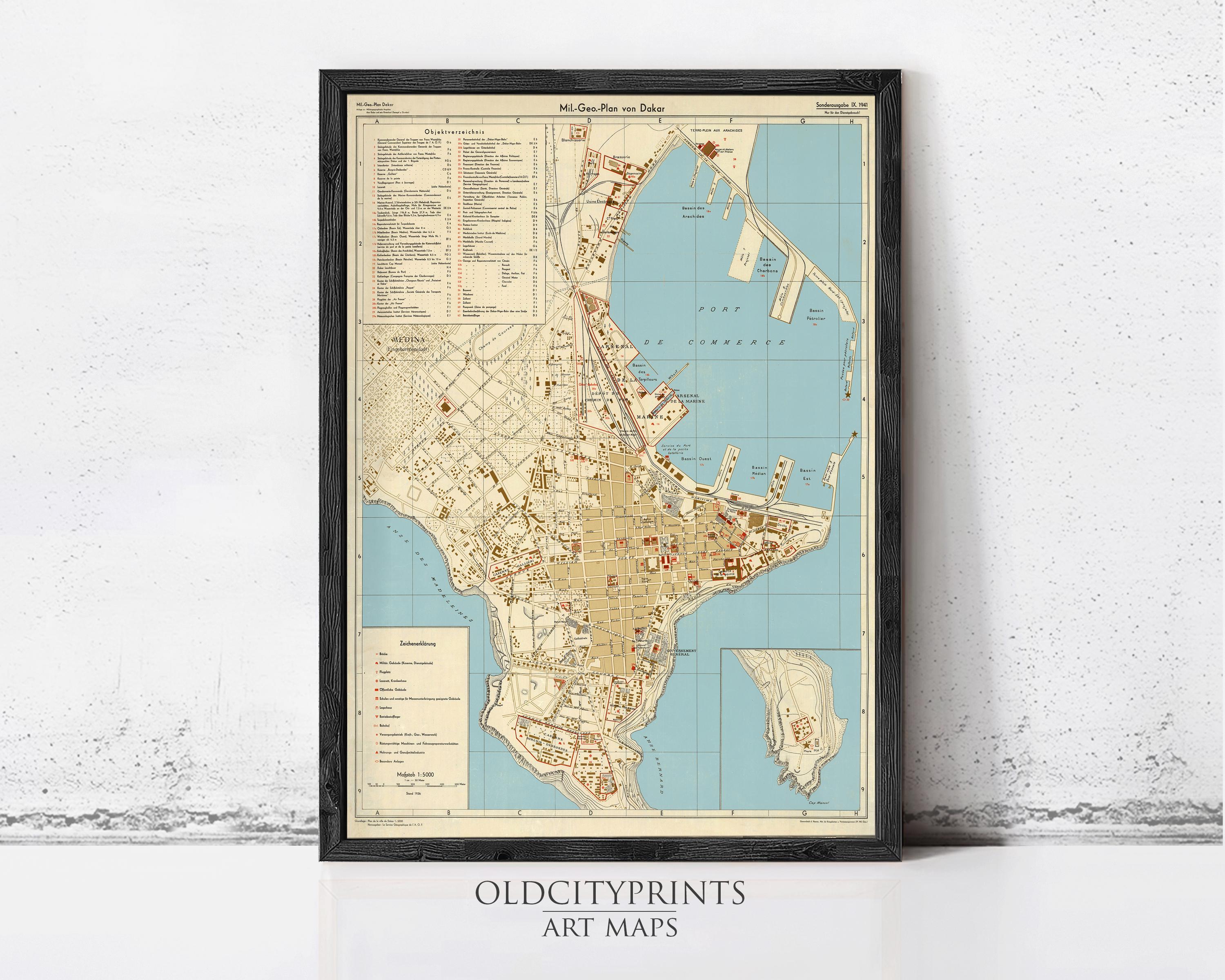 The image is a framed vintage map of an old city, likely from the 19th century, displayed on a wall.