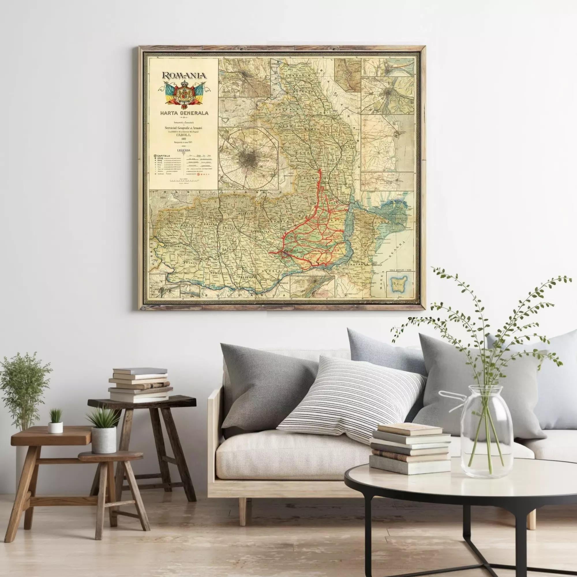 a large framed map of Romania hanging on a wall above a couch and a coffee table in a living room setting.