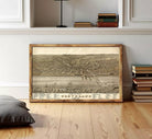 The image is a framed vintage map of Cleveland, Ohio, depicting the city's layout and surrounding areas.