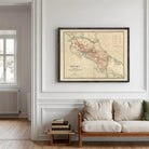 a large framed map of Costa Rica hanging on a white wall in a living room.