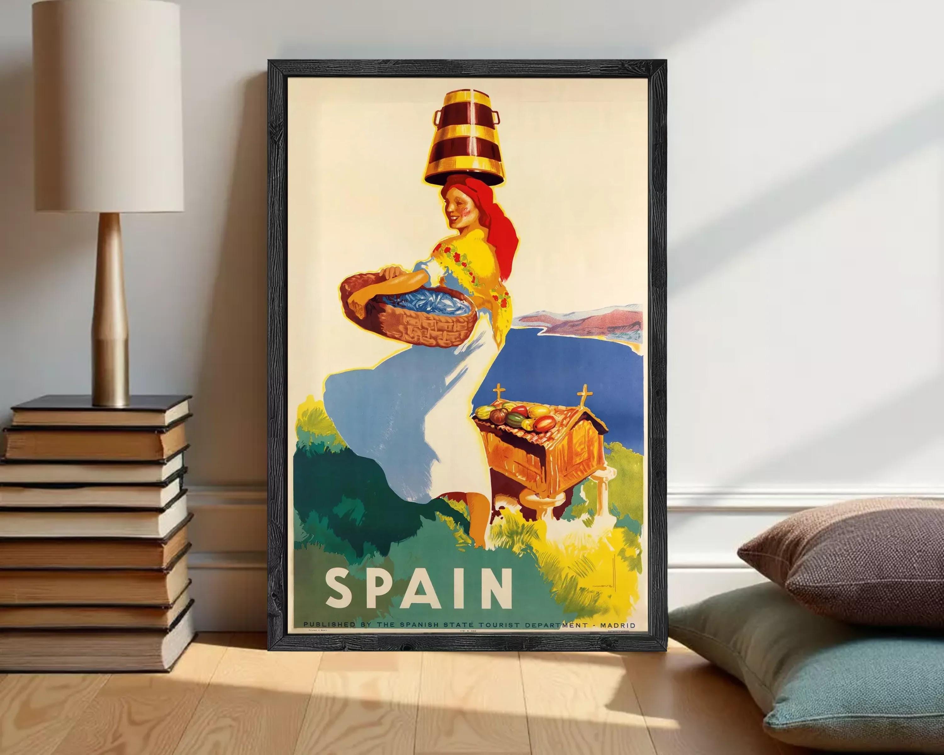 A framed vintage travel poster depicting a woman carrying a basket of fruit, with the word "SPAIN" prominently displayed.
