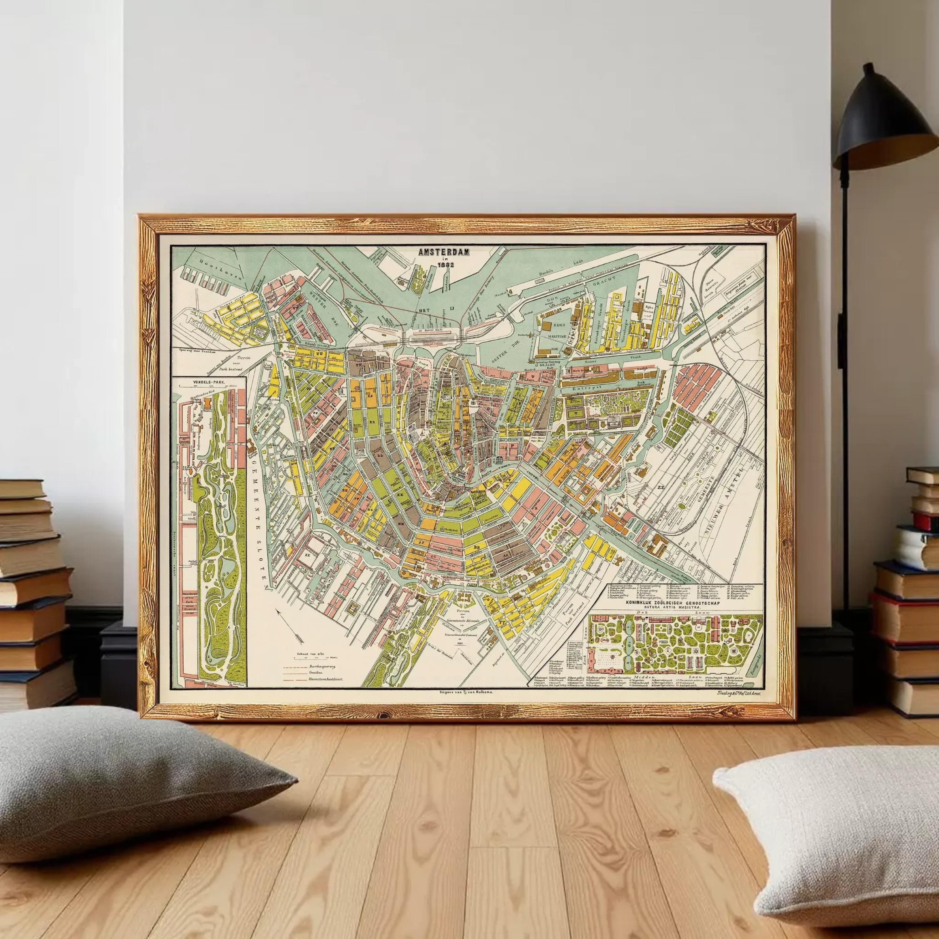 a large, colorful map of Amsterdam, Netherlands, displayed on a wooden floor in a room with books and a lamp.
