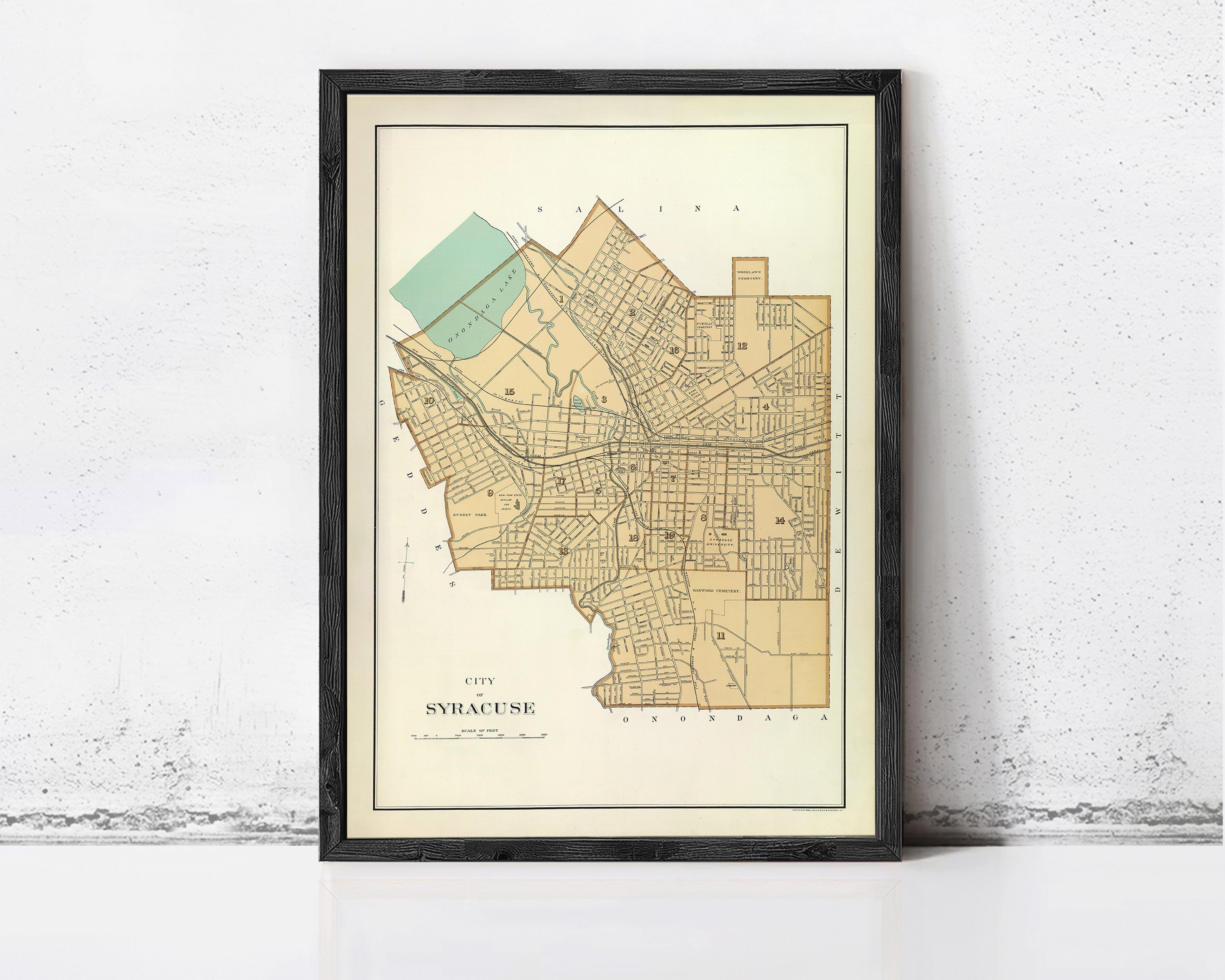 A framed map of the city of Syracuse, New York, with a vintage style and a light brown color scheme.