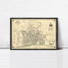 The image is a framed vintage map of a city, depicting streets, buildings, and other urban elements.