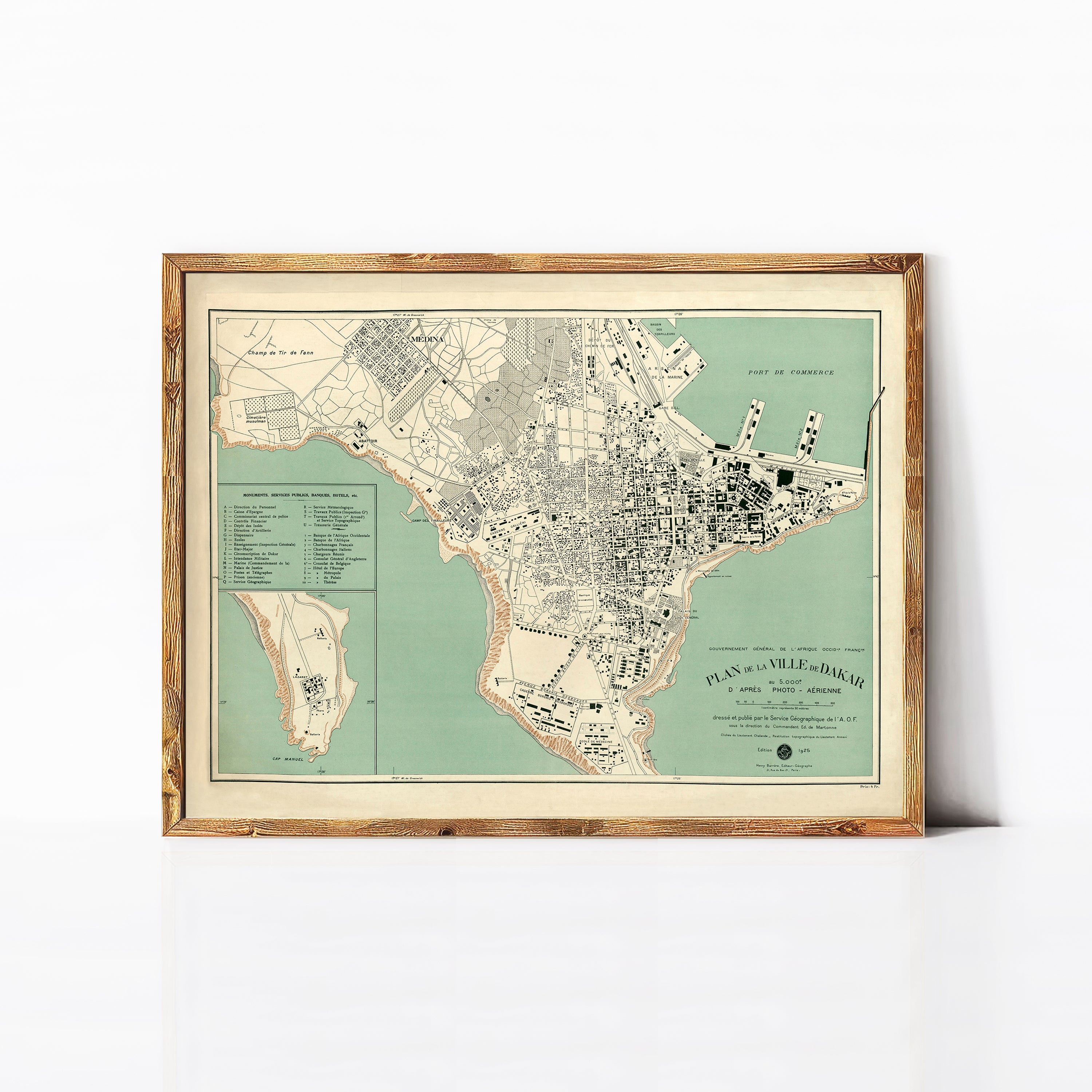 The image is a framed vintage map of a city, depicting a detailed layout of the streets, landmarks, and surrounding areas.