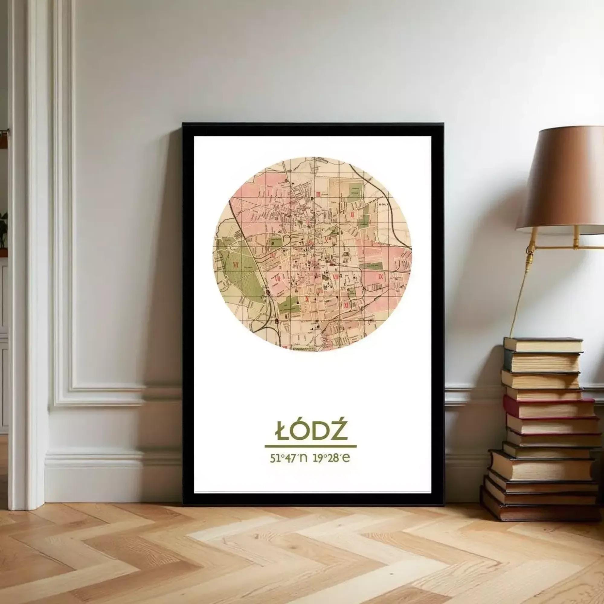 A framed map of a city, with a circular design and a map of the city displayed on it, is leaning against a wall next to a stack of books and a lamp.