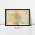 The image is a framed vintage map of a city, likely from the 19th century, displayed on a wall.