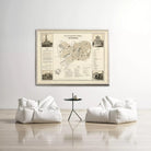 a large framed map of a city hanging on a wall, with two white bean bag chairs positioned in front of it.