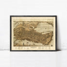 The image is a framed vintage map of a city, depicting a detailed layout of the city's streets, landmarks, and surrounding areas.