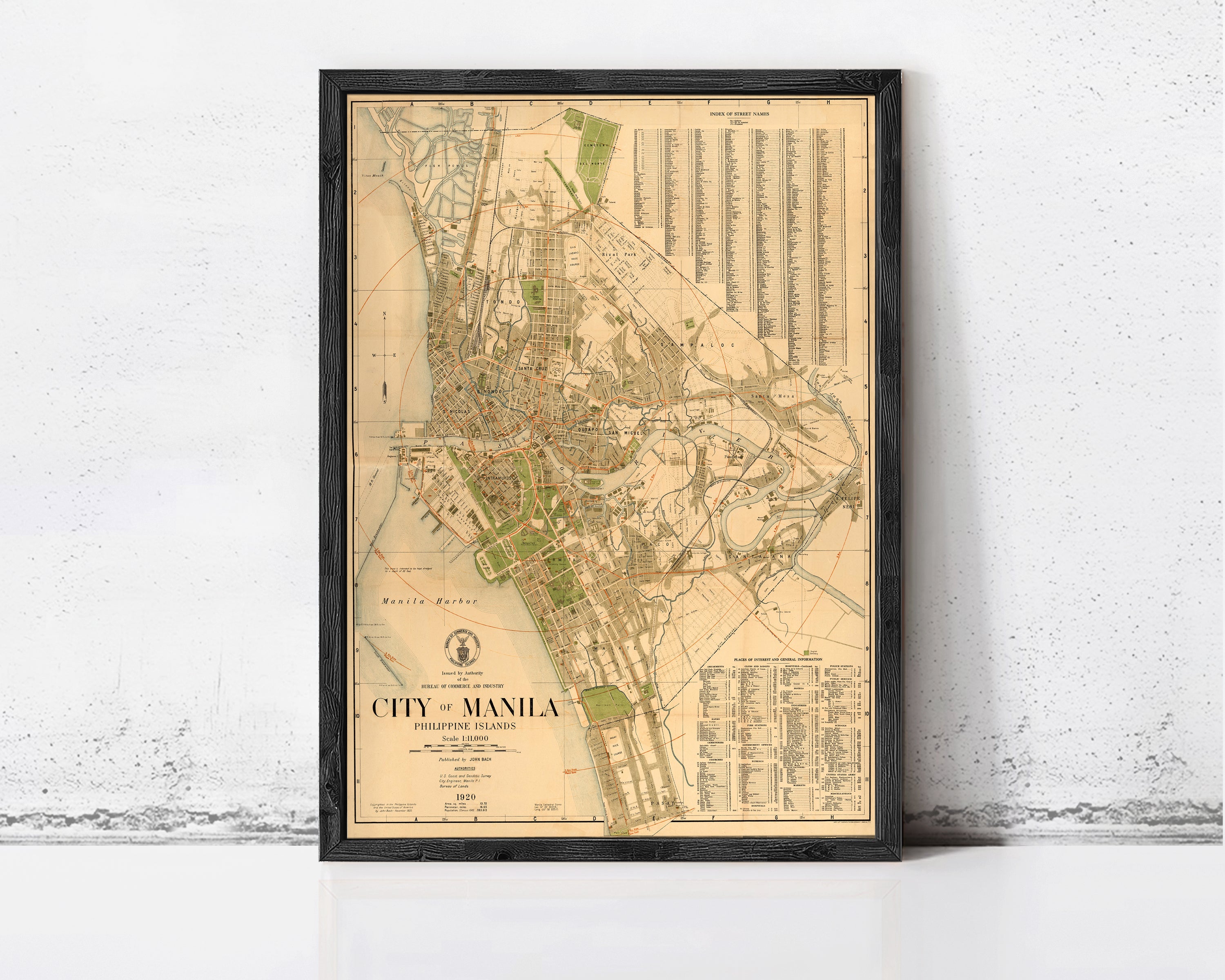The image is a framed map of Manila, Philippines, depicting the city's layout and surrounding areas.