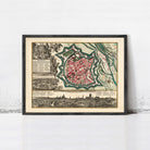 The image is a framed vintage map of a city, depicting a detailed layout of the city's streets, buildings, and surrounding landscape.