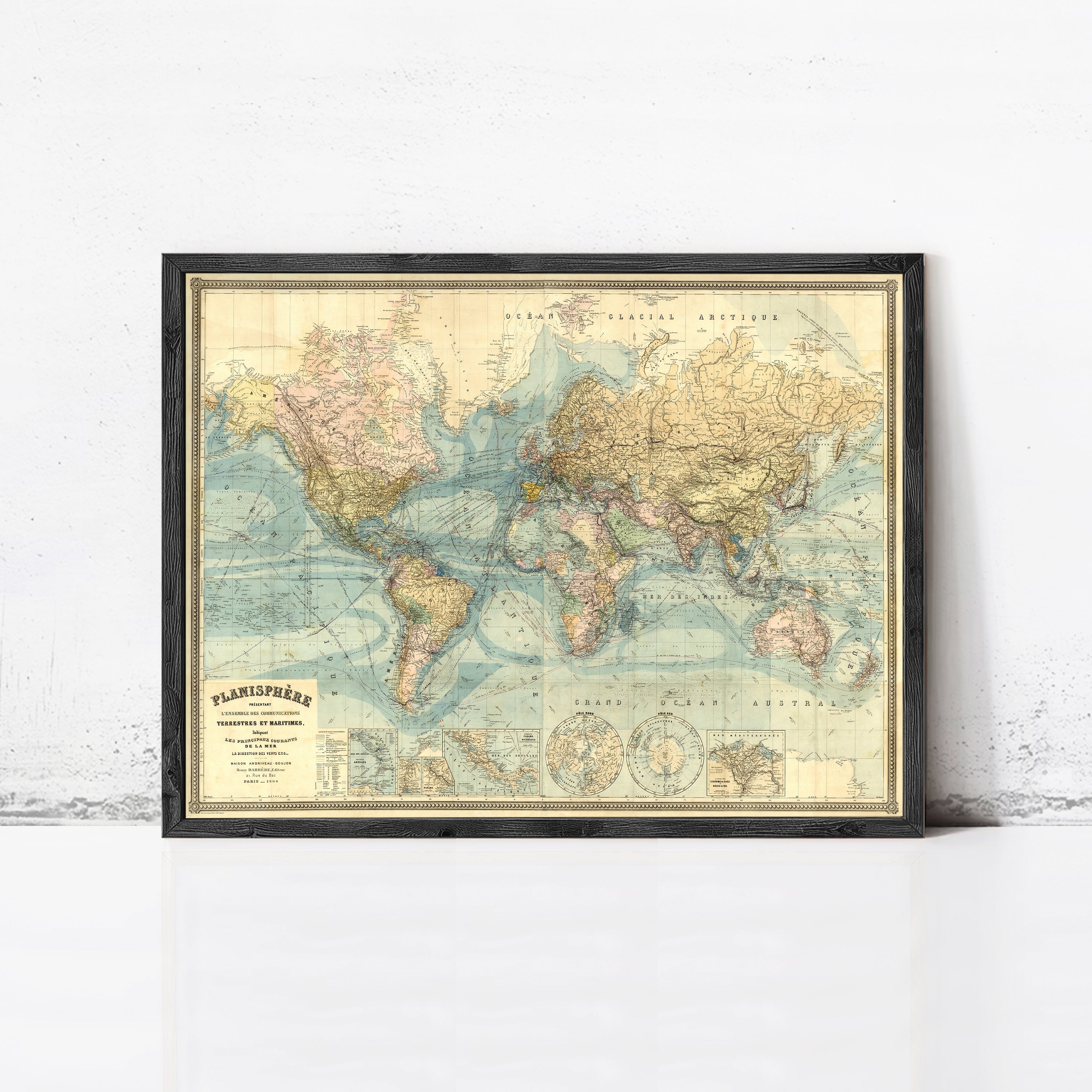 The image is a framed vintage map of the world, depicting the continents and oceans in a detailed and colorful manner.