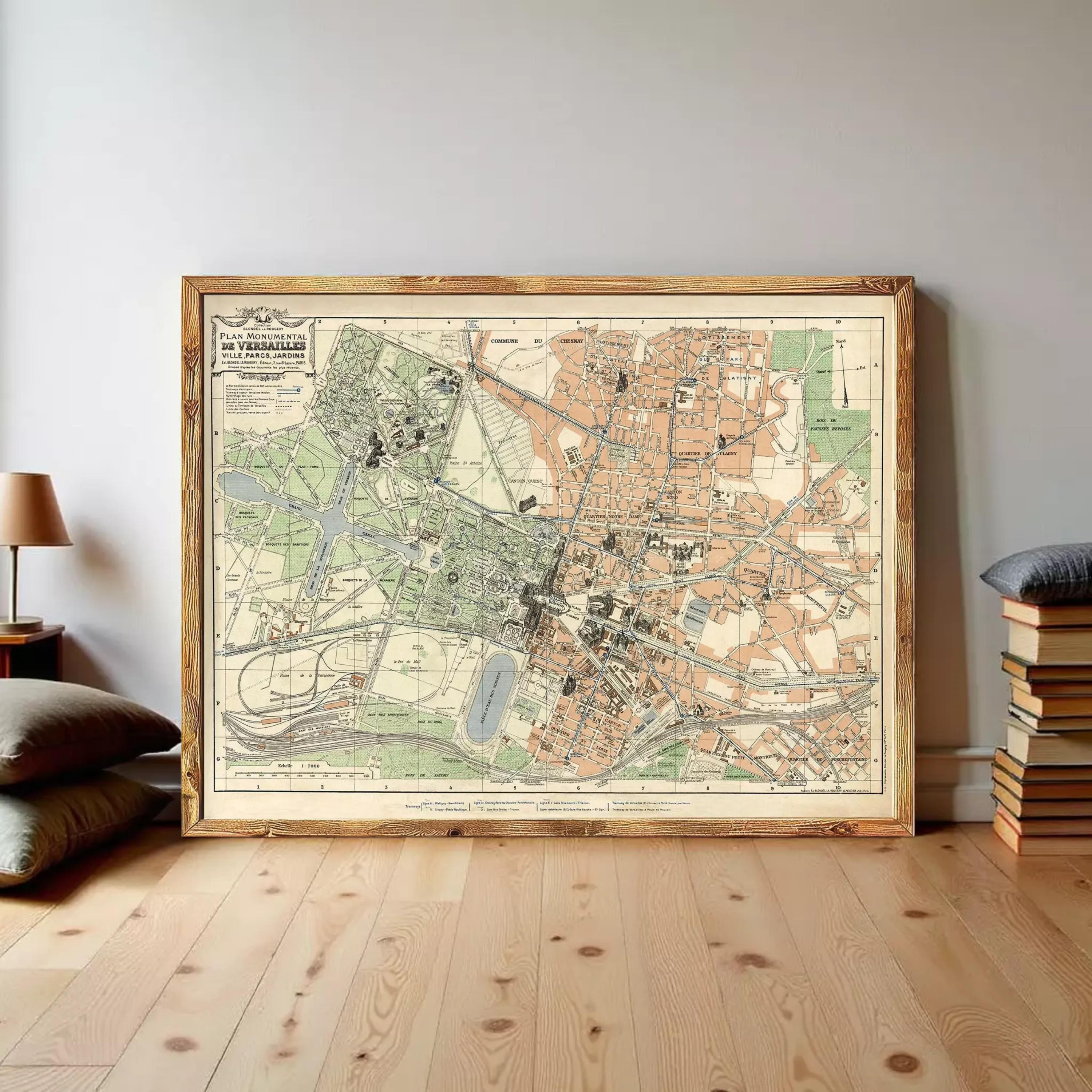 a large framed map of a city, with a wooden floor and a stack of books to the right.