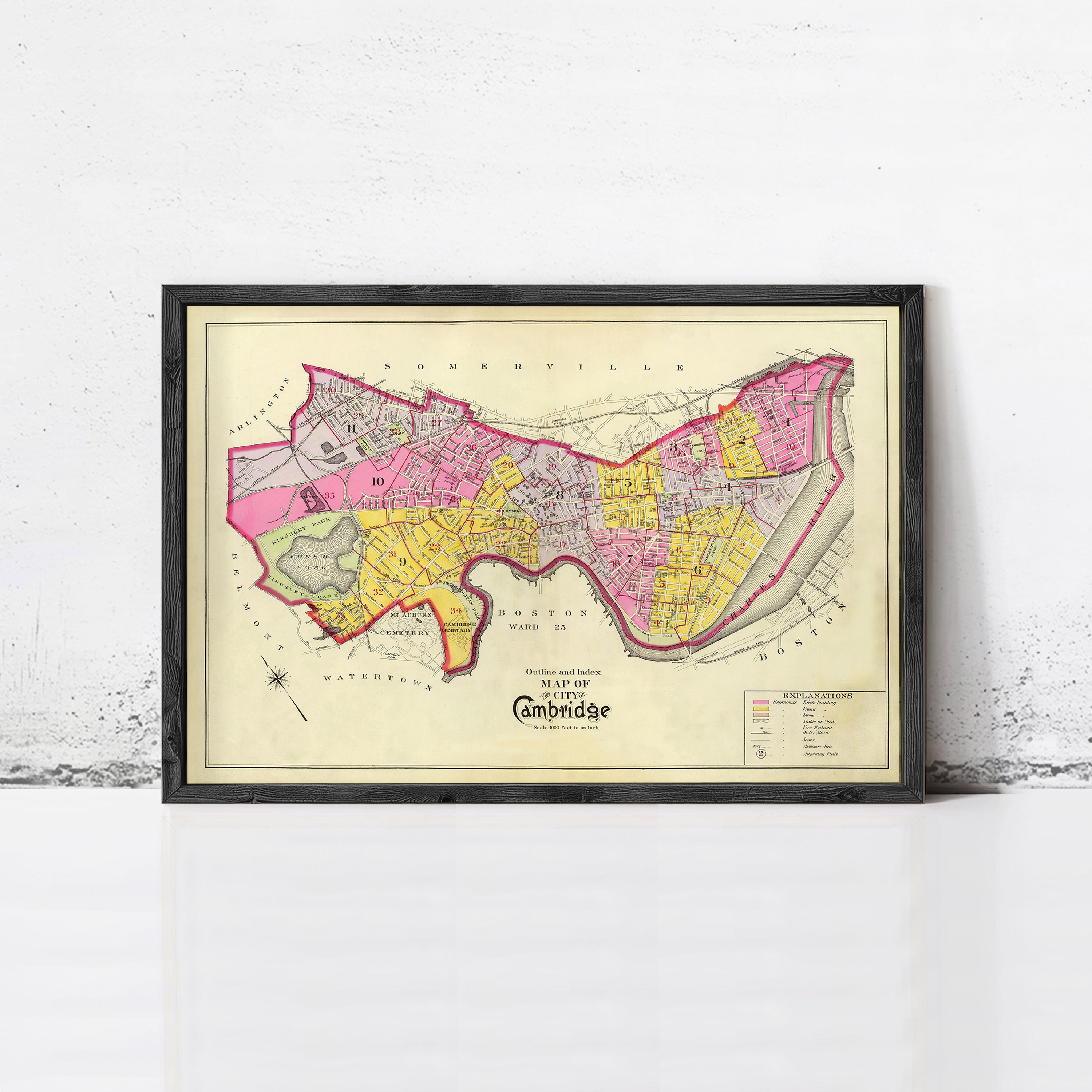 The image is a framed vintage map of Cambridge, England, depicting the city's layout and surrounding areas.