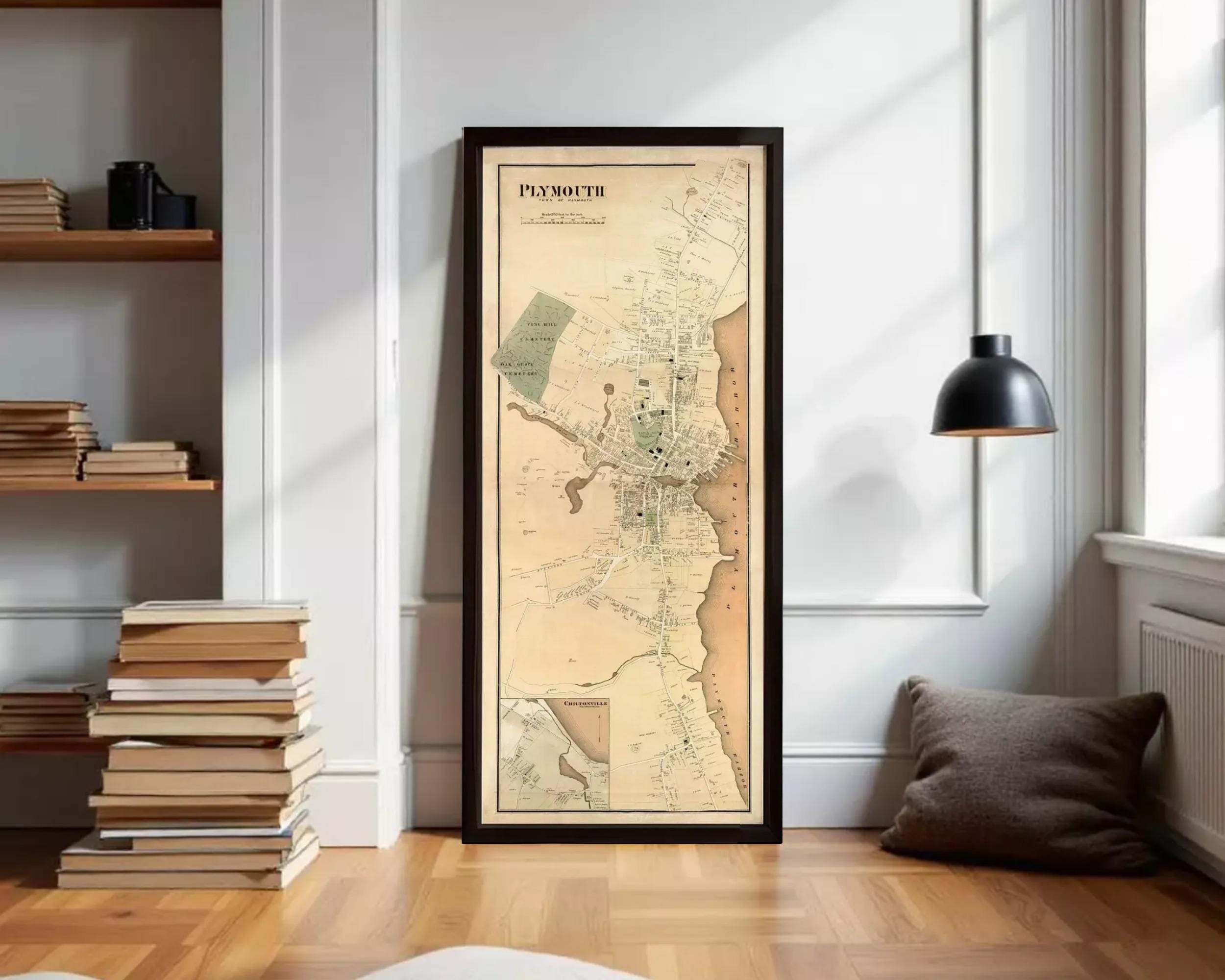 A framed map of Plymouth, Massachusetts, depicting the city's layout and surrounding areas.