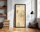 A framed map of Plymouth, Massachusetts, depicting the city's layout and surrounding areas.