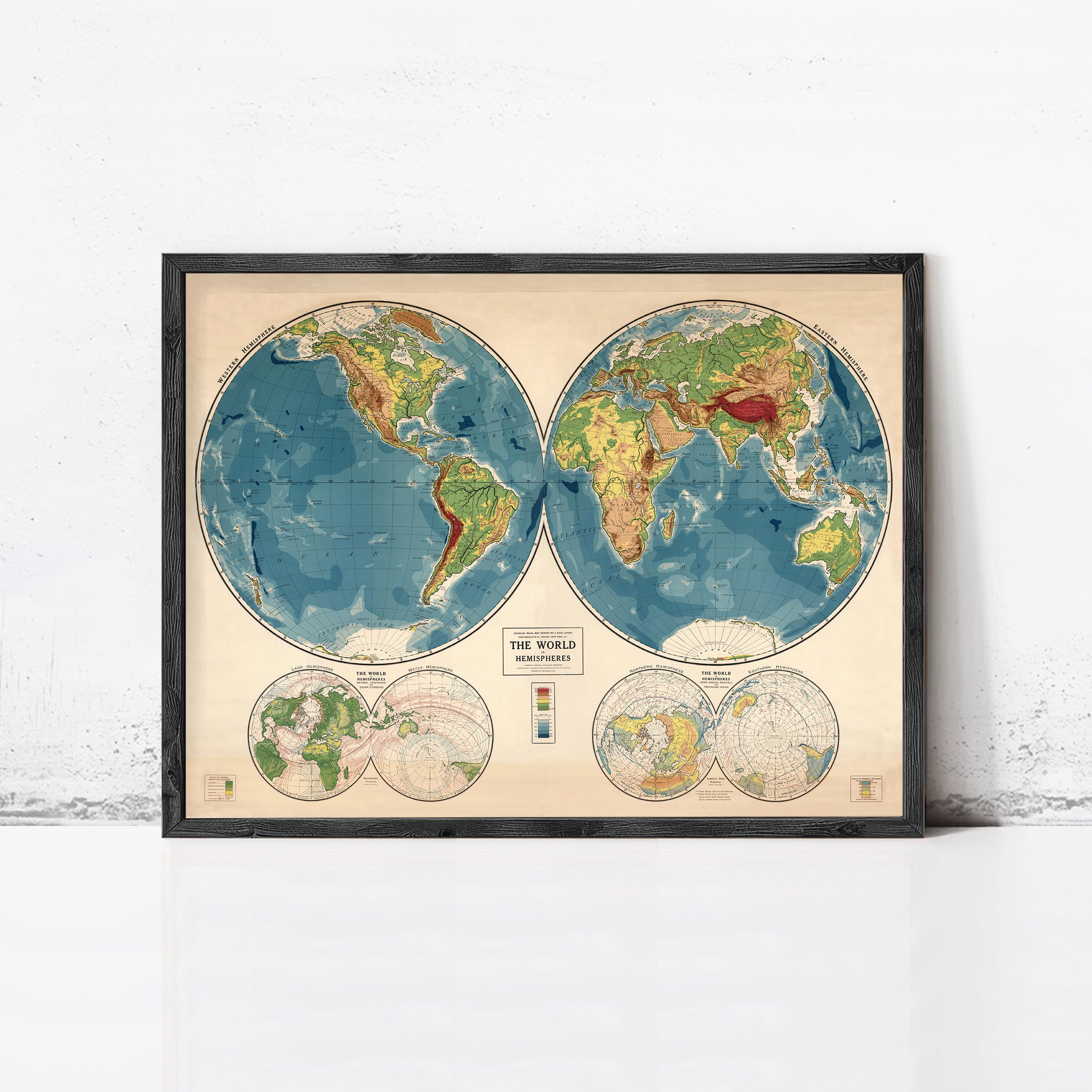 The image is a framed vintage map of the world, depicting the continents and oceans in a detailed and colorful manner.
